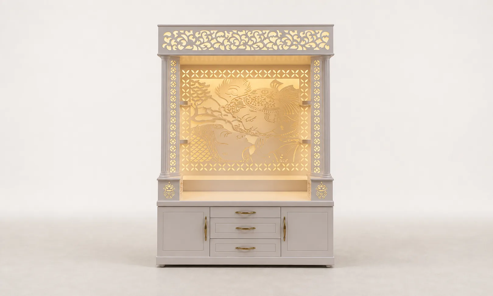 Light grey mandir unit with a wide backlit Radha-Krishna jaali panel and fretwork frieze.