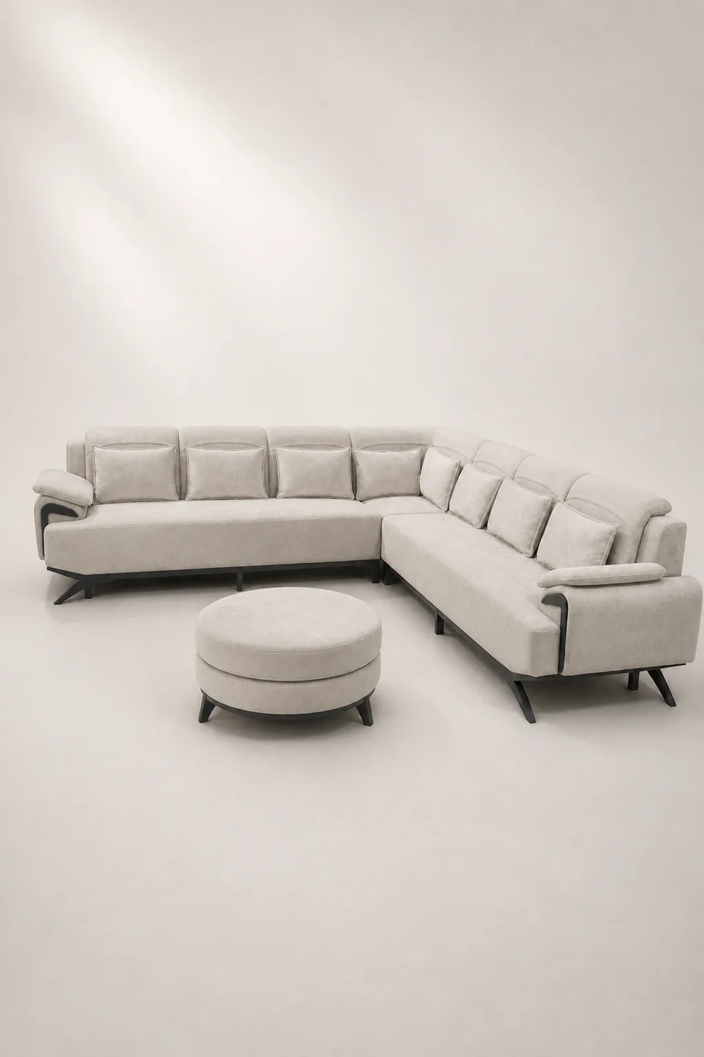 Cream channel-tufted U-shaped sectional sofa with round ottoman.
