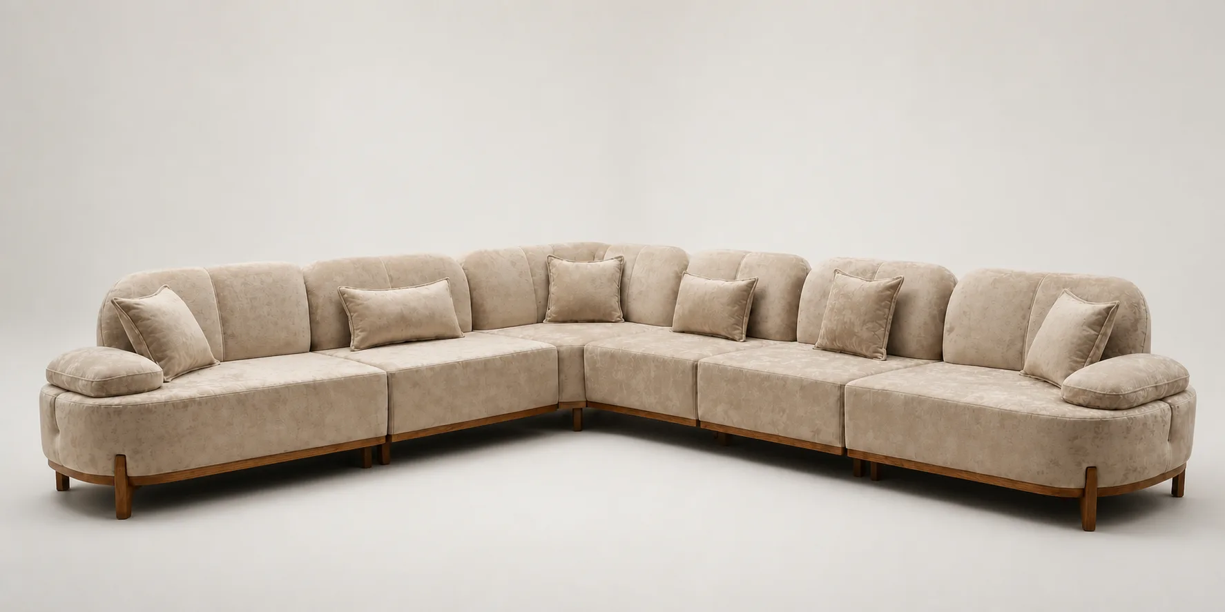 Tan extra-long U-shaped sectional sofa with channel-tufted backrests.