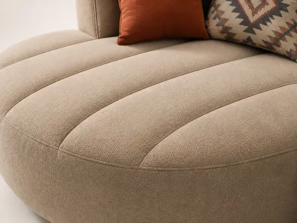 Close-up of vertical channel tufting detail on taupe sofa